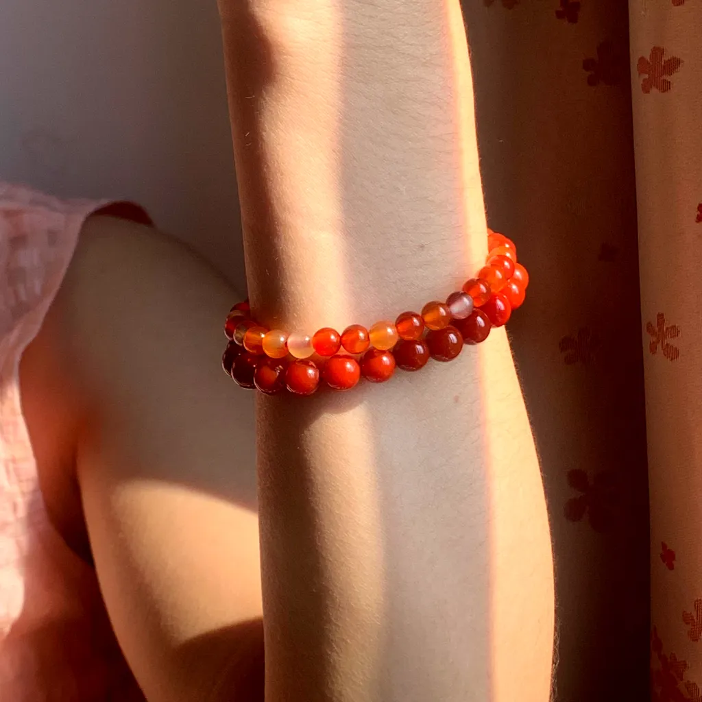 Fire Element Bracelet layered with Red Agate Bracelet on the wrist — a stacked everyday styling