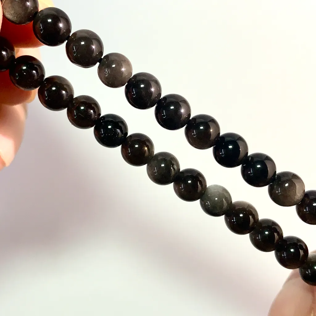 Obsidian Bracelet detail — glossy black volcanic glass surface