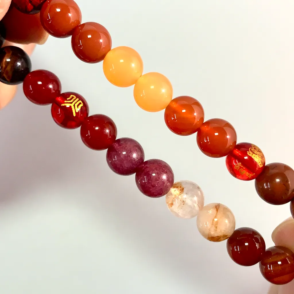 Close-up of the Fire Element Bracelet: red carnelian, red tiger eye and blood sand grains showing their natural inclusions