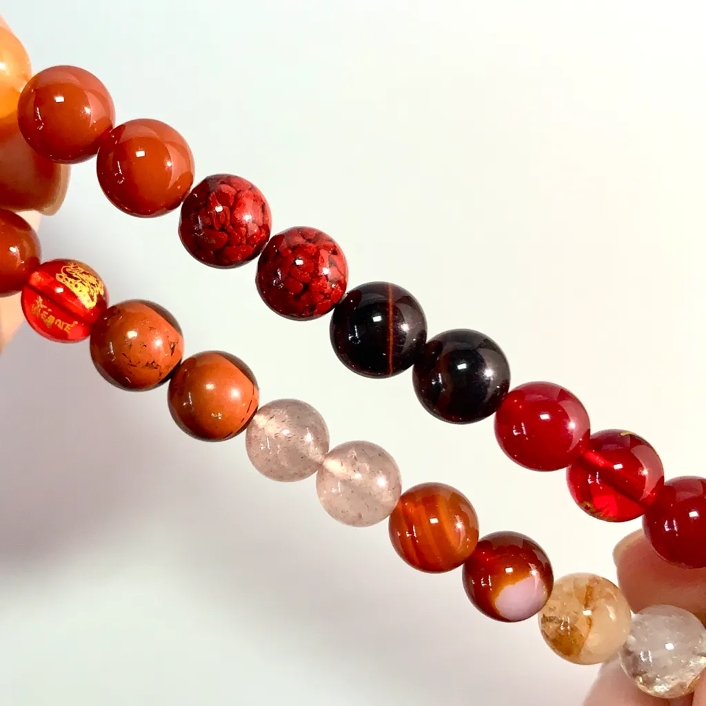 Close-up of the Fire Element Bracelet: red carnelian, red tiger eye and blood sand grains showing their natural inclusions