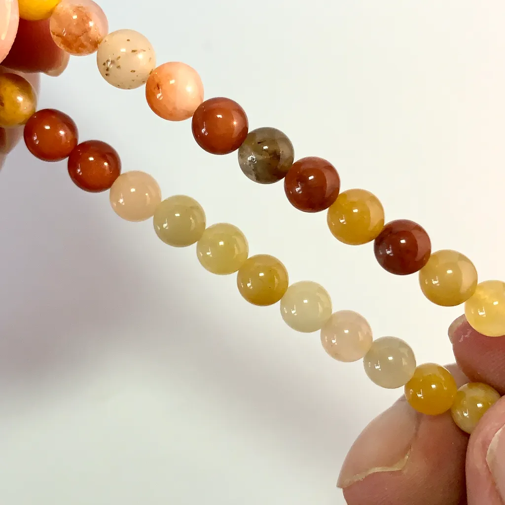 Close-up of Golden Silk Jade beads showing natural golden threads